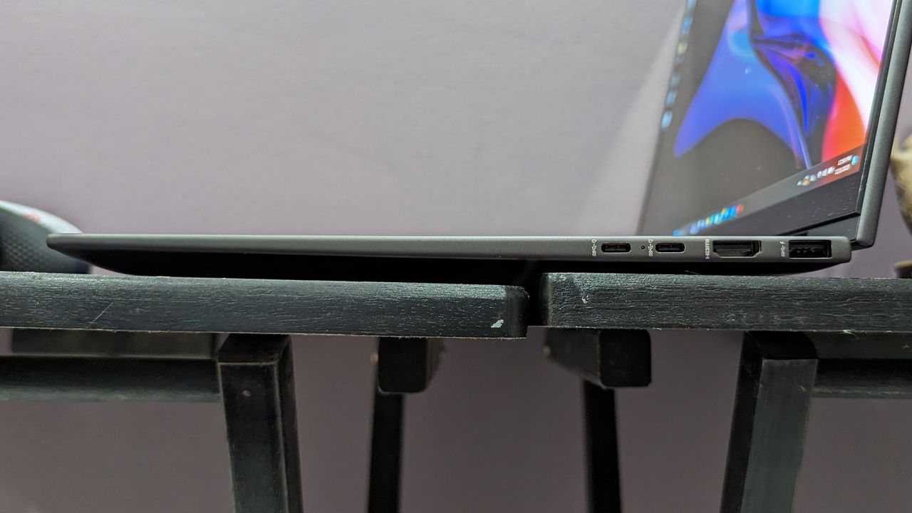 Side-on photo of the HP Envy x360's right-side ports on a black desk.