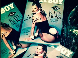 Kate Moss holds up a copy of her new Playboy cover