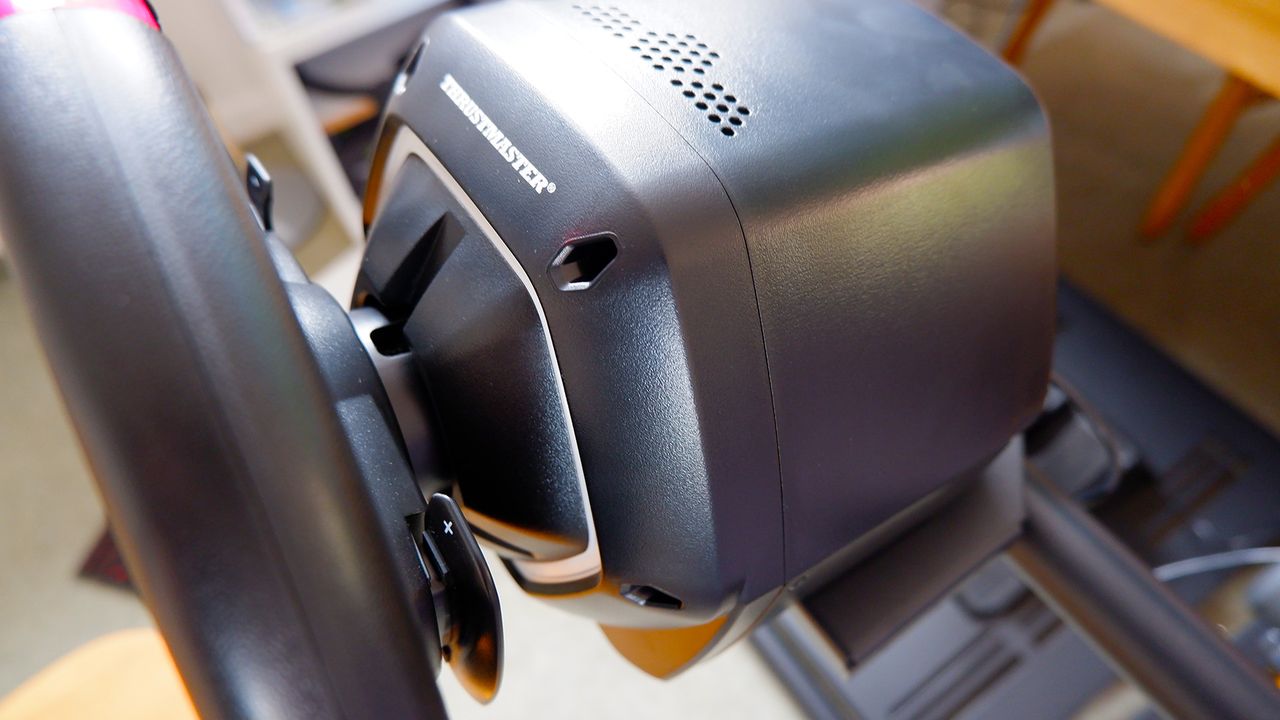 The Thrustmaster T128 racing wheel mounted on a Monoprice stand.