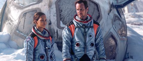 Halle Berry and Patrick Wilson standing in the snow, in their spacesuits, in Moonfall.