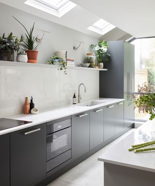 Modern kitchen with white gloss countertops and styled open shelving