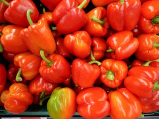 Lots of red peppers in a supermarket basket