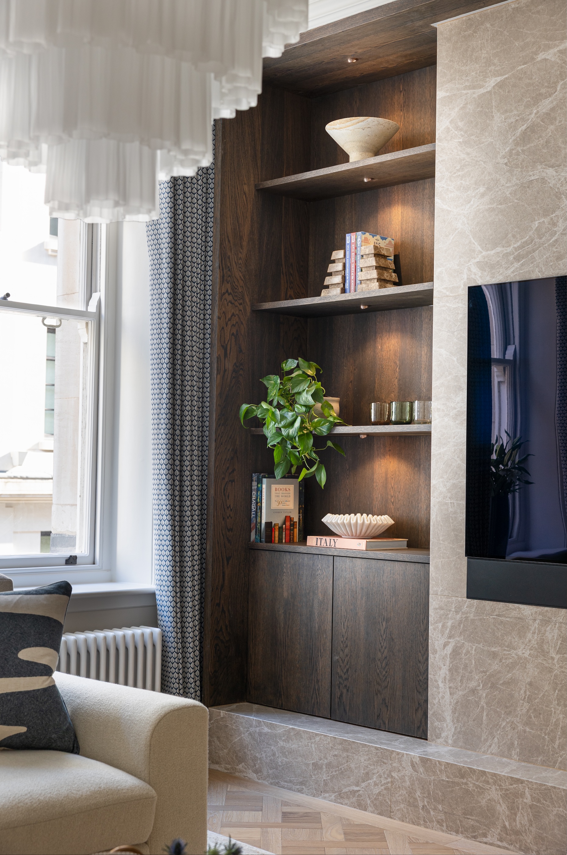 Open shelving in an alcove with lighting creating a warm glow