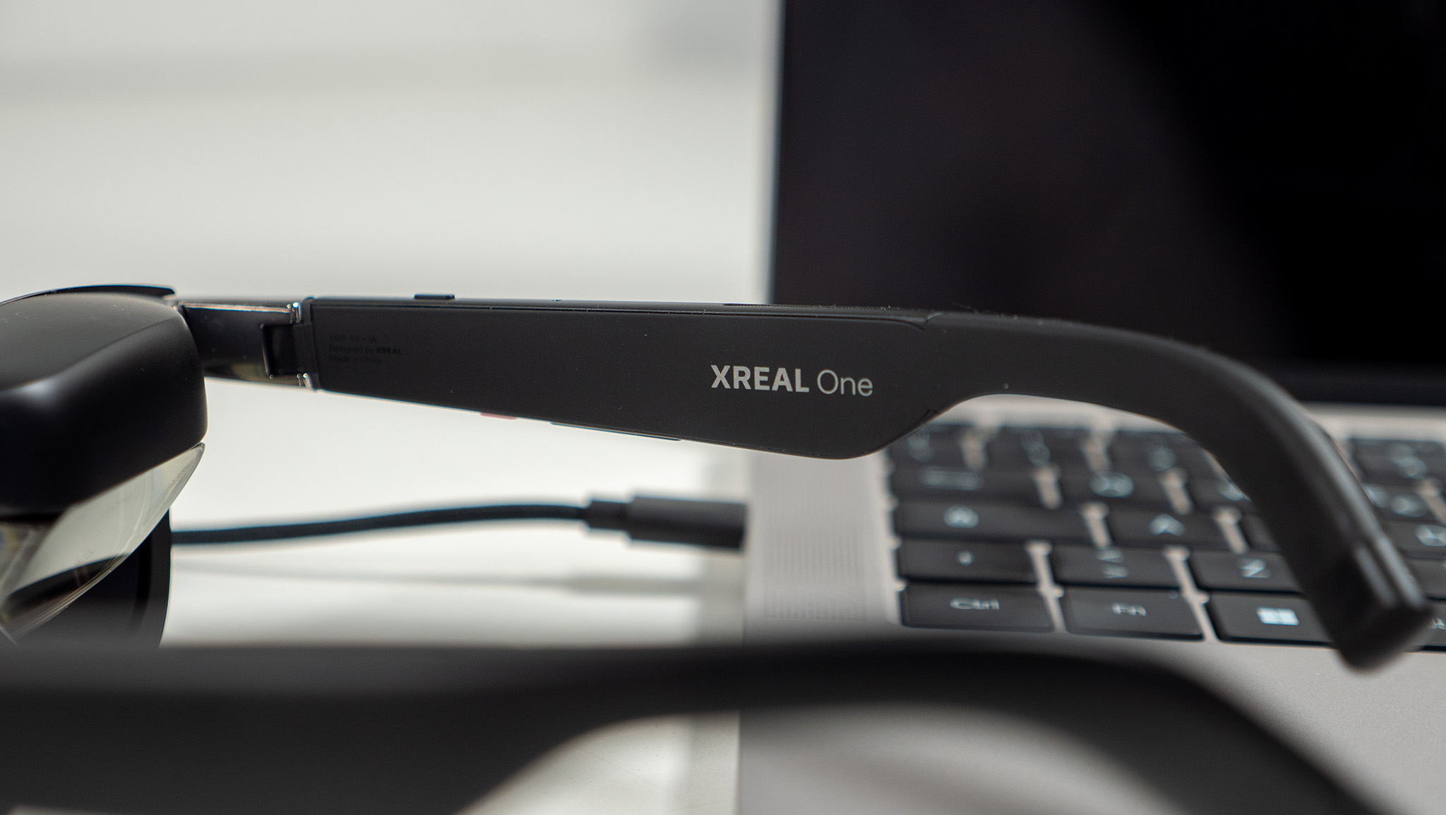 A close-up look at Xreal One logo on Xreal One smart glasses