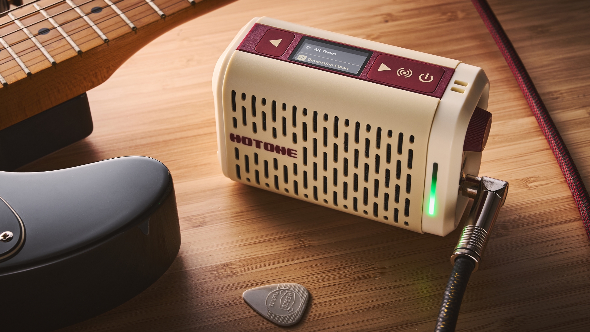 A Hotone Ampero Mini amp with a guitar cable plugged into it