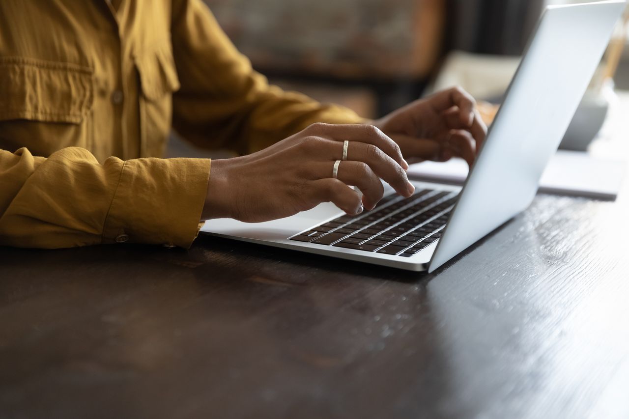 Person typing on laptop.