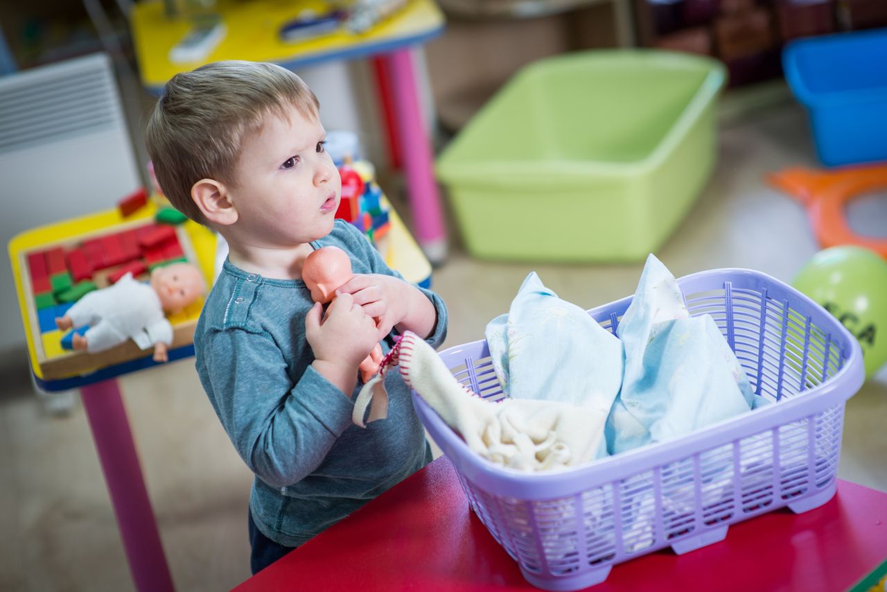 A boy plays with dolls.