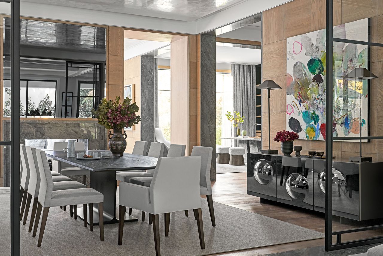 Dining room with neutral colors and gray taupe with shiny sideboard