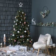 christmas tree with baubles and dark grey wall