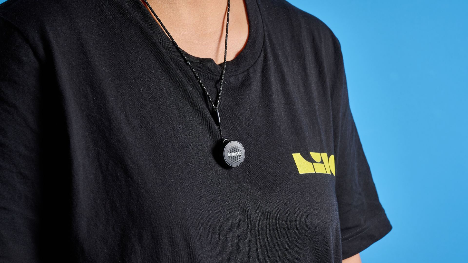 Insta360 Mic Air photographed on a blue background