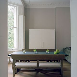 dinning room with grey wall white window blue dinning table with grey seat