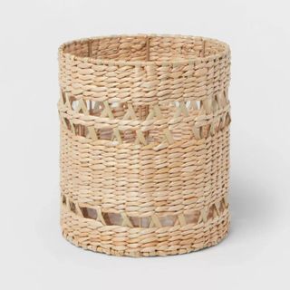 A small woven trash can