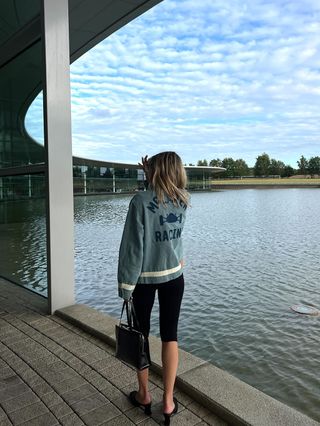 Eliza Huber wearing a denim Levi's x McLaren jacket with a white Levi's T-shirt and black capri pants at the McLaren Technology Center.