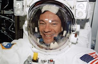 NASA astronaut Michael Lóopez-Alegria smiles for a photo while preparing for a spacewalk outside the International Space Station in November 2002 during the STS-113 mission.