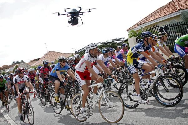 The mini TV-helicopter hovers above the riders