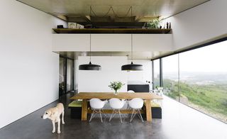 The pared-down interiors feature a polished concrete floor and ascending ceiling
