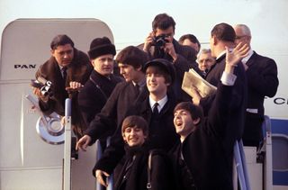 The Beatles arriving at JFK, New York, USA in 1964 ahead of their unprecedented rise to fame.