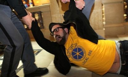 A Wisconsin protester is dragged away Thursday: Pro-union groups respond to state Republicans' late-night vote to curb collective bargaining rights for public workers. 