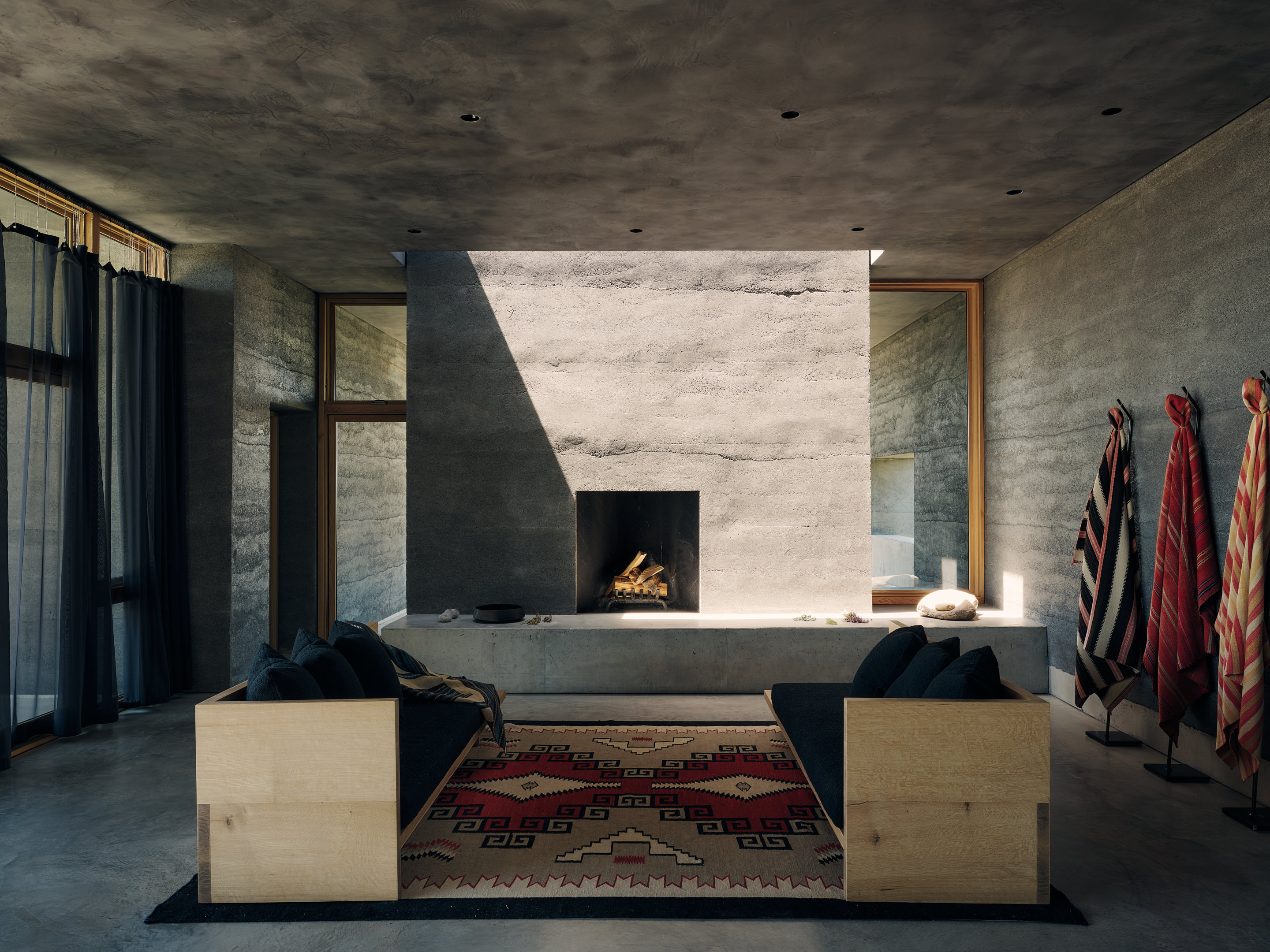 views of Sombra de Santa Fe, new mexico house, with dark, minimalist geometric volumes and clean walls and long nature views