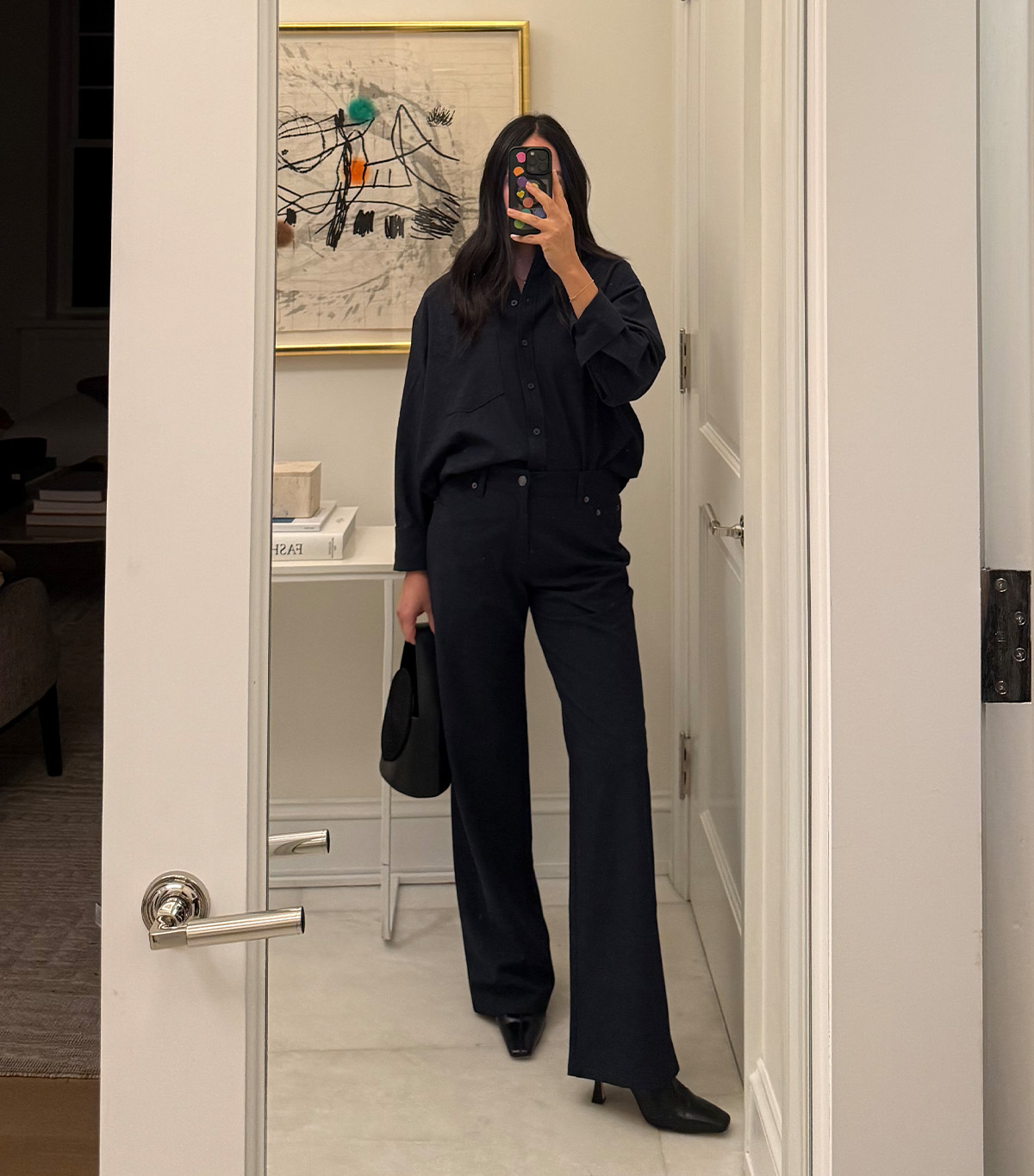 @nicoleakhtarzad taking a mirror selfie wearing a winter outfit.