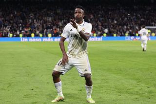 Real Madrid's Brazilian forward Vinicius Junior celebrates after scoring his team's third goal during the Copa del Re quarter-final against Atletico Madrid