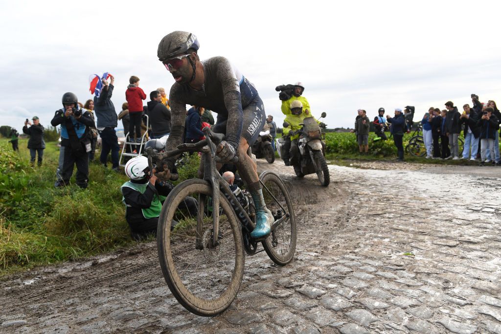 ROUBAIX FRANCE OCTOBER 03 Tom Van Asbroeck of Belgium and Team Israel StartUp Nation covered in mud covered in mud competes through cobblestones sector during the 118th ParisRoubaix 2021 Mens Eilte a 2577km race from Compigne to Roubaix ParisRoubaix on October 03 2021 in Roubaix France Photo by Tim de WaeleGetty Images