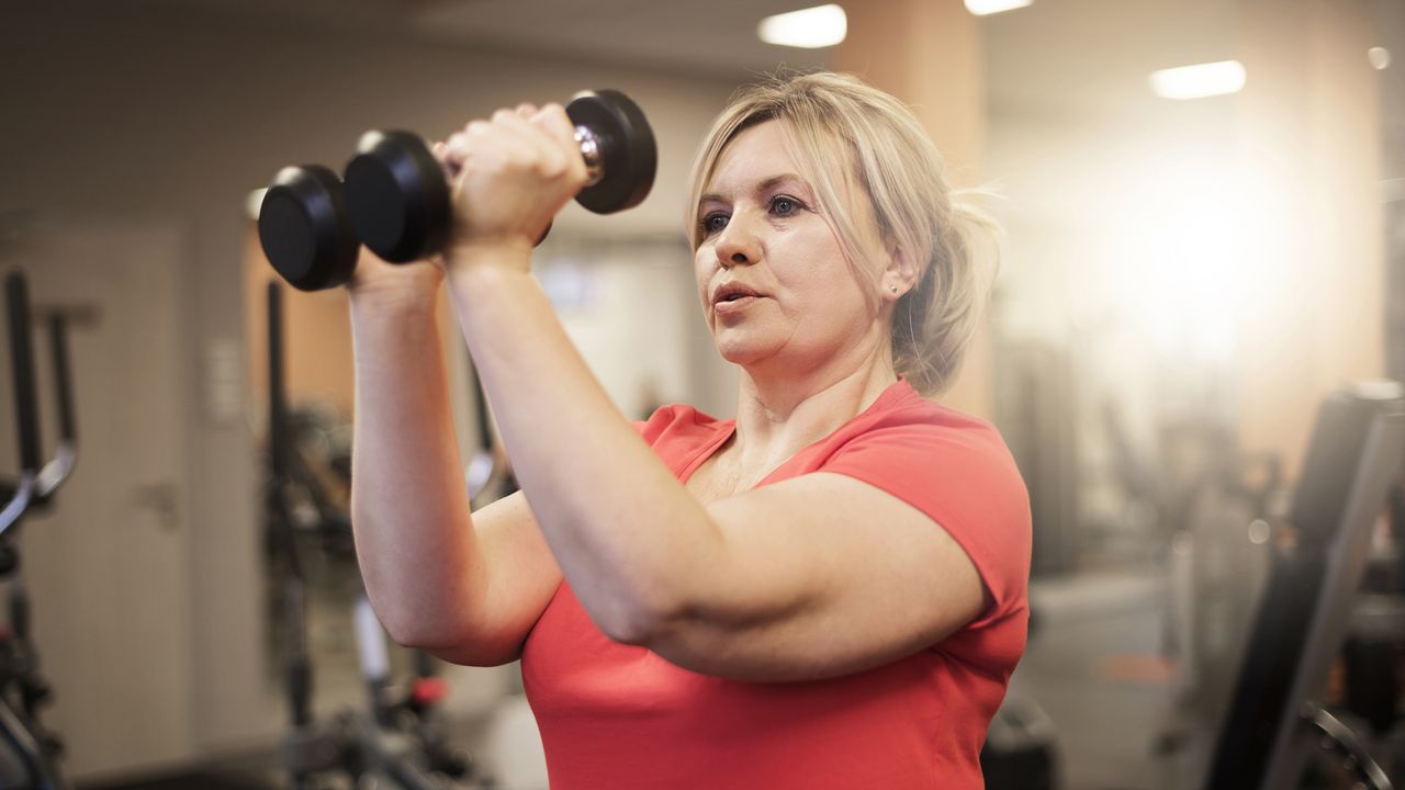 Woman working with dumbbells