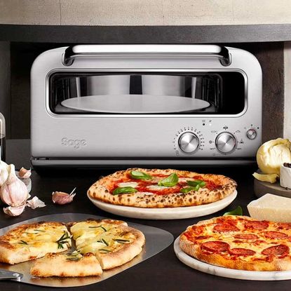 Sage Smart Oven Pizzaiolo and multiple cooked pizzas