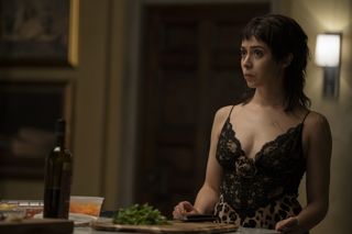 A photo of Sofia Falcone from The Penguin in a black lace and leopard print slip dress