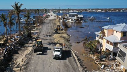In this aerial view, construction crews work around the clock to make temporary repairs to a bridge on the island of Matlacha on October 05, 2022 in Matlacha Florida
