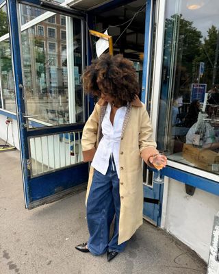 Trench coat with white blouse and jeans outfit