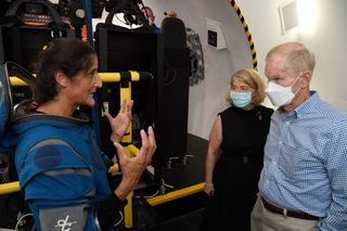NASA Administrator Bill Nelson (at right) and Deputy Administrator Pam Melroy (second from right) talk with astronaut Suni Williams, who is training at Johnson Space Center to fly on Boeing's Starliner spacecraft to the International Space Station.