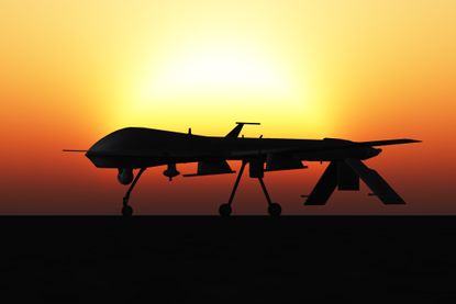 General Atomics MQ-1 Predator drone ready to take off at sunset.