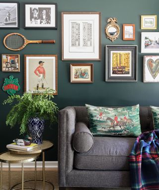 forest green living room with a sentimental gallery wall with knickknacks and a racket