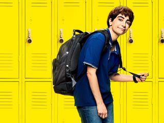 Nasim Pedrad as Chad, in front of yellow lockers, in art for Chad.