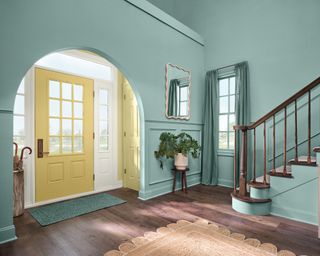 teal blue entryway with yellow front door