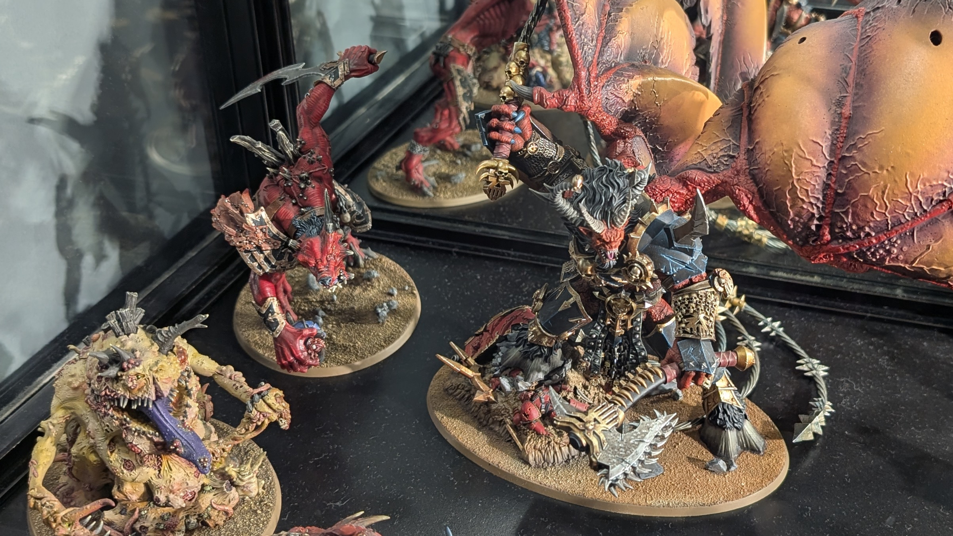 A trio of daemons from Warhammer 40,000 on display