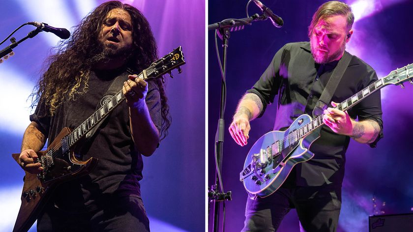 Coheed and Cambria&#039;s Claudio Sanchez and Travis Stever perform live on a stage lit in purple.