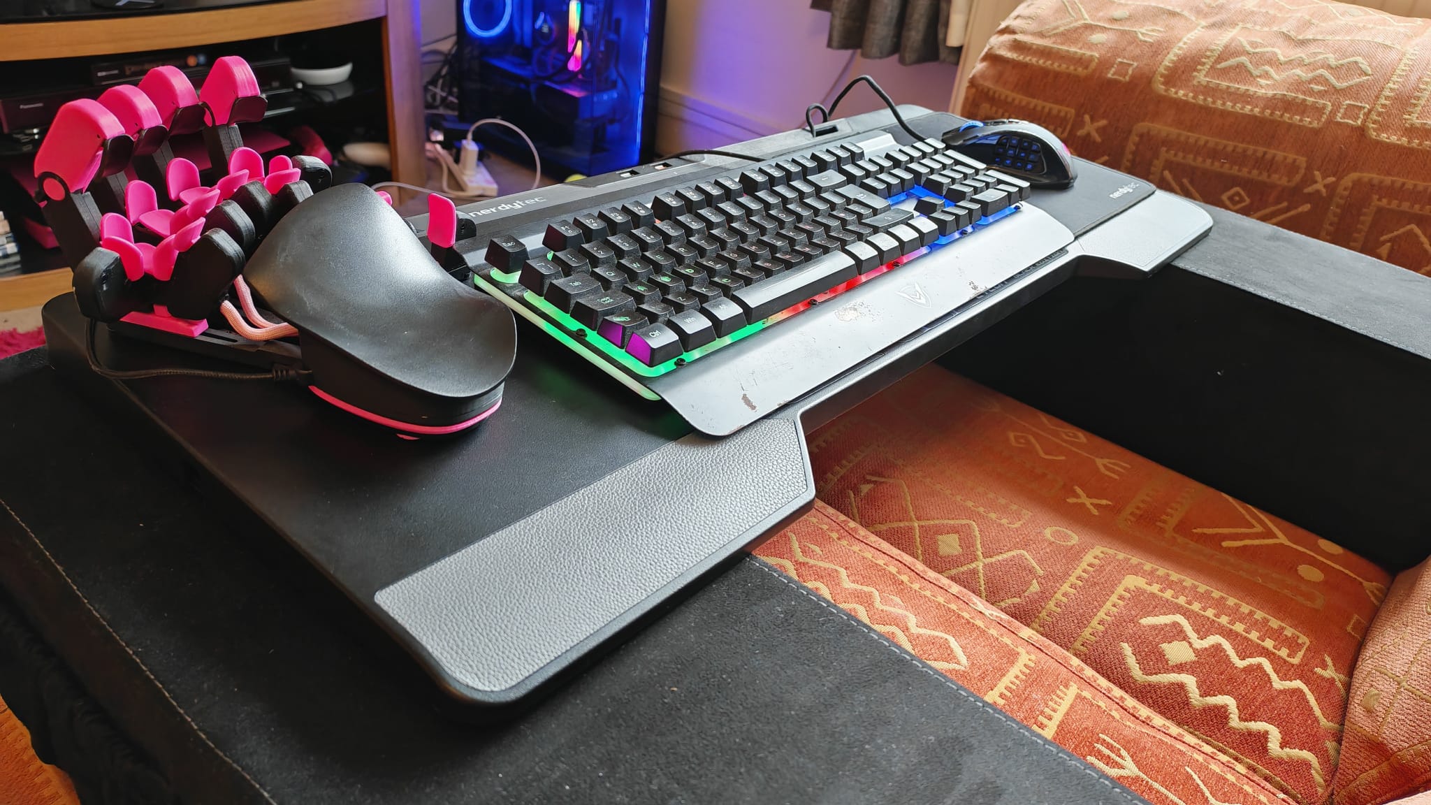 Couchmaster Cycon 2 gaming desk setup with a mouse, keyboard, and gaming keypad on it