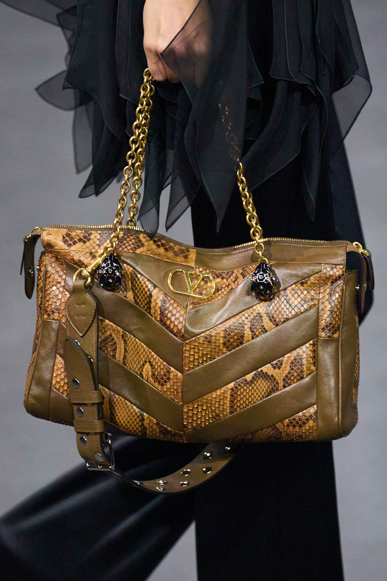 Model carrying a snakeskin Valentino bag.