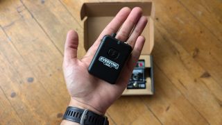 The Cloudvocal EverSync receiver in the palm of a man's hand