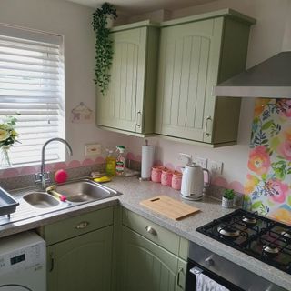 green kitchen with sink and pastel accessories