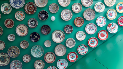 a green kitchen ceiling covered in patterned plates