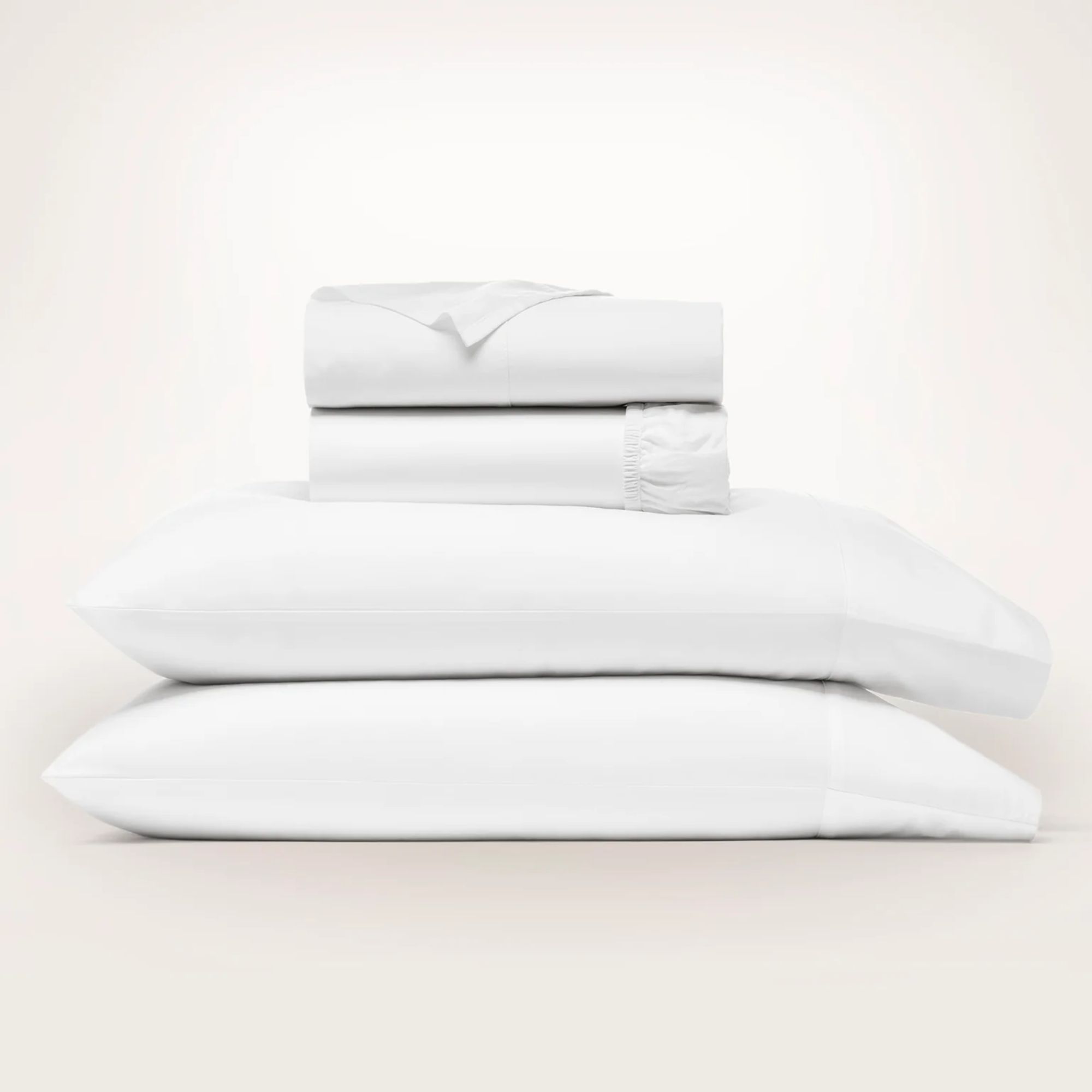 A stack of white Boll &amp;amp; Branch Signature Hemmed Sheets