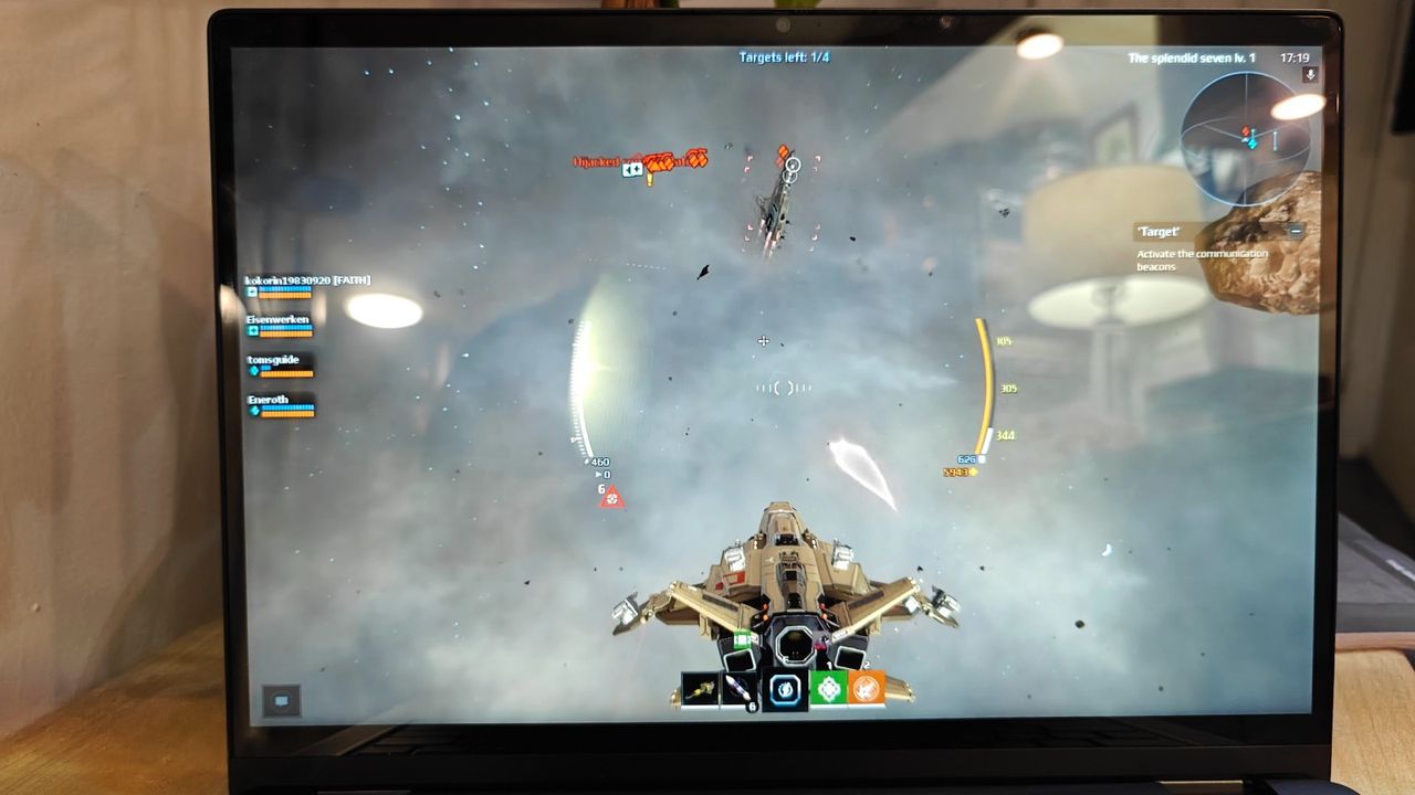 Close up of a laptop display showing a video game with an aircraft flying through clouds