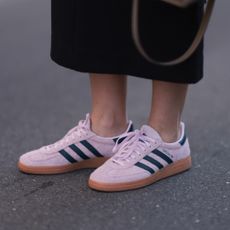 A guest at fashion week wearing pink adidas sneakers