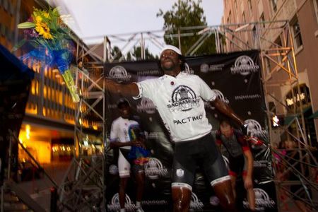 Podium flowers to the crowd from the winner in the Pactimo winner's jersey.