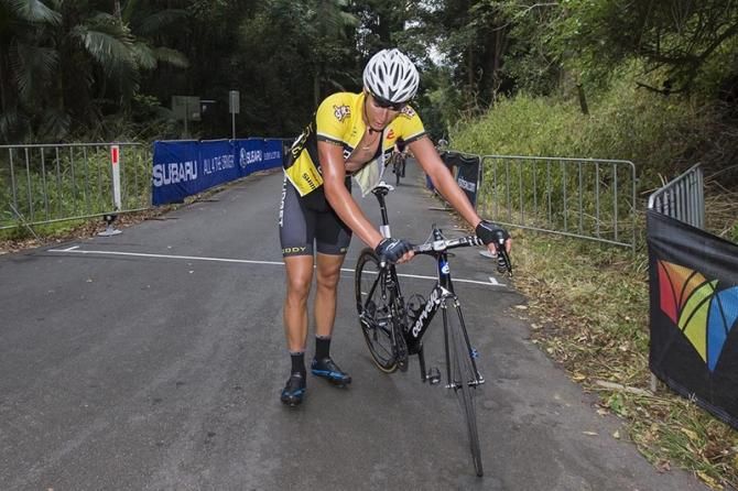 Alex Wohler (Budget Forklifts) crosses the line and dismounts as soon as possible after the harsh climb
