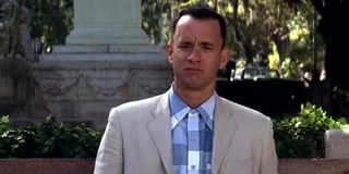 Tom Hanks as Forrest Gump sitting on a bench