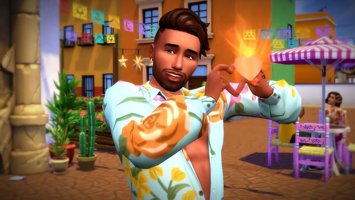 The Sims 4 Lovestruck reveal trailer screenshot showing a young man with short brown hair and trimmed facial hair standing, smiling while holding his hands up in a heart shape